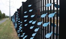 Britosterope fence complete with blue wind-spoon plastic elements simulating water